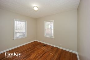 Atlanta house for rent - a bedroom with a hard wood floor and two windows