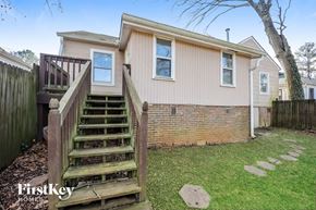 Atlanta house for rent - the exterior of a home with stairs and a wooden deck