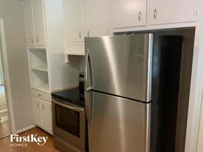 Stone Mountain house for rent - a stainless steel refrigerator in a kitchen with white cabinets