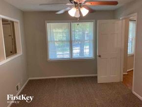 Stone Mountain house for rent - a room with a ceiling fan and a door and a window
