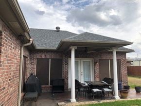 Youngsville house for rent - a patio with chairs and a table on a brick house