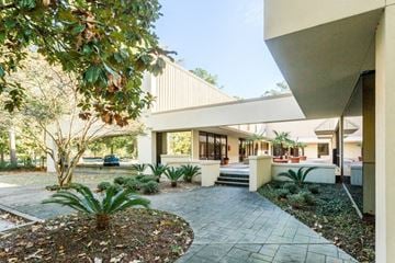 Mandeville apartment for rent - a house with a walkway and a garden
