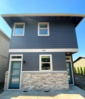 Forest Grove house for rent - A two-story house with a stone wall at the entrance.