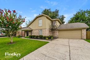 Deer Park house for rent - a beige house with a driveway and a lawn