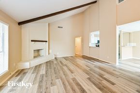 Deer Park house for rent - a living room with wood flooring and a fireplace