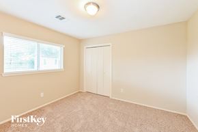 Deer Park house for rent - a bedroom with a door to a closet and a window