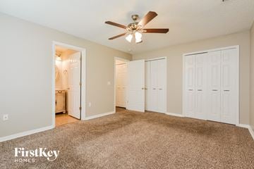 Apopka house for rent - a living room with carpet and a ceiling fan