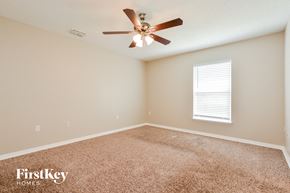 Apopka house for rent - the master bedroom has a ceiling fan and a carpeted floor