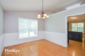 Covington house for rent - an empty dining room with wood floors and a chandelier