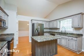 Covington house for rent - a kitchen with granite counter tops and stainless steel appliances