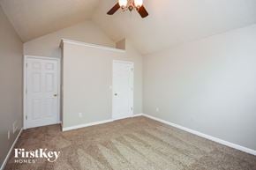 Covington house for rent - a bedroom with carpet and white doors and a ceiling fan