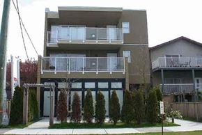 Vancouver apartment for rent - A modern two-story apartment building with balconies and a small garden in front.