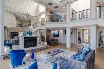 Dunwoody apartment for rent - a large living room with a fireplace and blue furniture