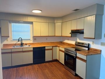 Port Royal - Available Now apartment for rent - A kitchen with wooden floors and a window.