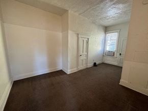 Fremont apartment for rent - A room with brown carpet and white walls.