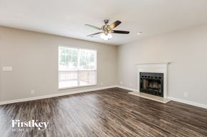 Antioch house for rent - a living room with a fireplace and a ceiling fan