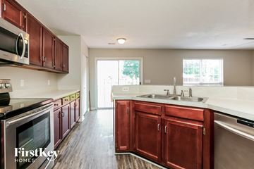 Antioch house for rent - a kitchen with wooden cabinets and a sink and a stove