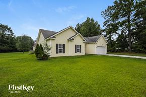Moncks Corner house for rent - A house with a white garage door and a black roof.