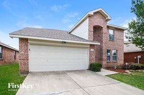 Princeton house for rent - A brick house with a garage door that says FirstKey Homes.