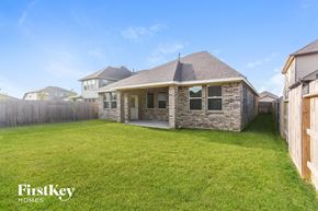 Missouri City house for rent - A house with a fence and a grassy yard is for sale.