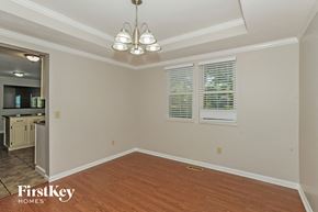 Mason house for rent - a dining room with wood floors and white walls and a chandelier