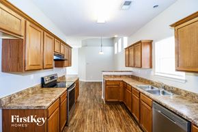 Memphis house for rent - a kitchen with wooden cabinets and stainless steel appliances