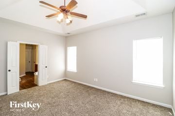 Memphis house for rent - a living room with a ceiling fan and a carpet