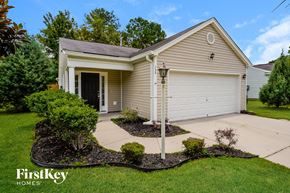 Summerville house for rent - the front of a house with a driveway and a white garage door