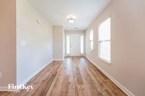 Summerville house for rent - a living room with wood flooring and white walls and a white door