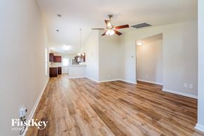Summerville house for rent - a living room with wood flooring and a ceiling fan