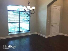 Joshua house for rent - an empty room with a large window and a door