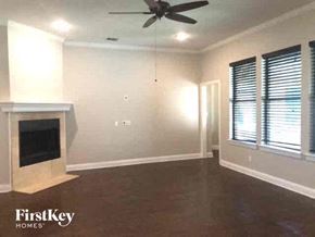 Joshua house for rent - a living room with a fireplace and a ceiling fan