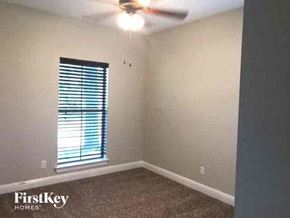 Joshua house for rent - an empty bedroom with a ceiling fan and a window