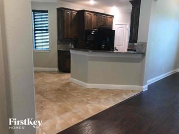 Joshua house for rent - a kitchen with a counter top and a black microwave