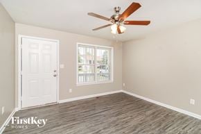 Greensboro house for rent - A room with a ceiling fan and a door leading to a balcony.