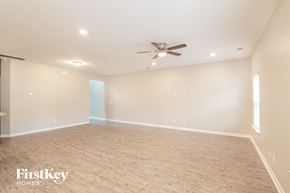 Summerville house for rent - a empty living room with a ceiling fan