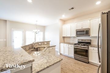 Summerville house for rent - a kitchen with granite counter tops and stainless steel appliances