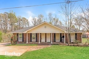 Powder Springs house for rent - A house with a front porch and a lawn.