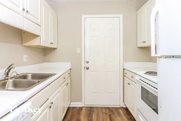 Powder Springs house for rent - A white door is in the middle of a kitchen.