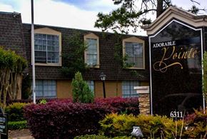 Houston apartment for rent - a building with a sign in front of it