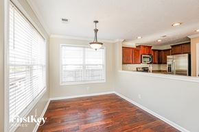 Clarksville house for rent - A well-lit kitchen with wooden floors and a large window.