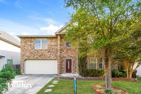 San Antonio house for rent - a large brick house with a tree in front of it