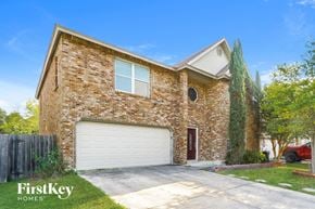San Antonio house for rent - the front of a brick house with a white garage door