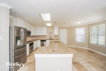 San Antonio house for rent - a kitchen with a granite counter top and stainless steel appliances