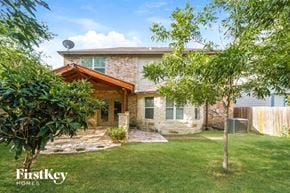 San Antonio house for rent - a small brick house with a yard and trees