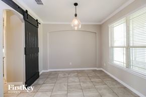 Haslet house for rent - an empty dining room with a black barn door