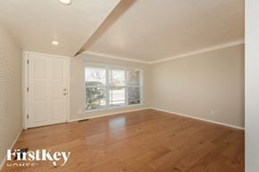 Saint Louis house for rent - A room with wooden floors and a white door.