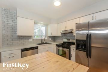 Saint Louis house for rent - A kitchen with a wooden table and stainless steel appliances.