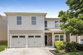 Mooresville house for rent - a white house with two garage doors