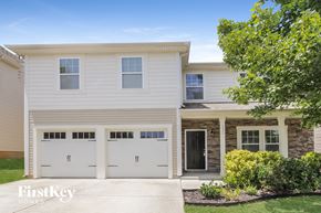 Mooresville house for rent - a white house with two garage doors